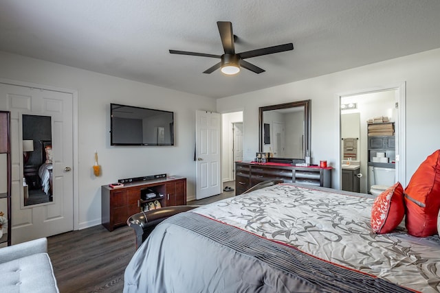 bedroom with ceiling fan, dark hardwood / wood-style flooring, a textured ceiling, and ensuite bath