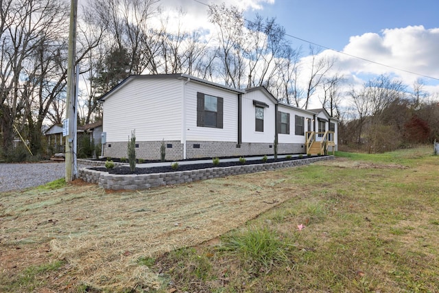 view of side of home with a yard