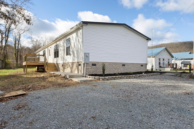 view of property exterior featuring a wooden deck