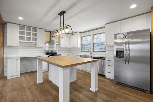 kitchen featuring a center island, white cabinets, hanging light fixtures, dark hardwood / wood-style floors, and stainless steel appliances