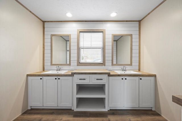 bathroom with vanity, wood-type flooring, and a textured ceiling