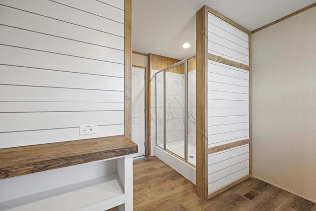 bathroom featuring hardwood / wood-style floors and wood walls