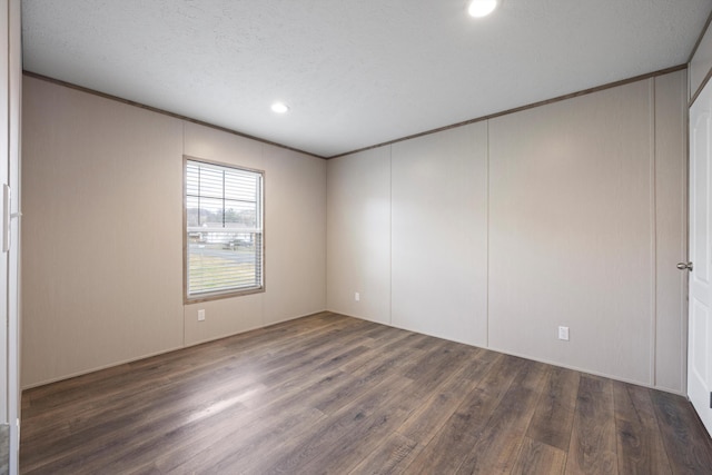 unfurnished room featuring crown molding and dark hardwood / wood-style floors