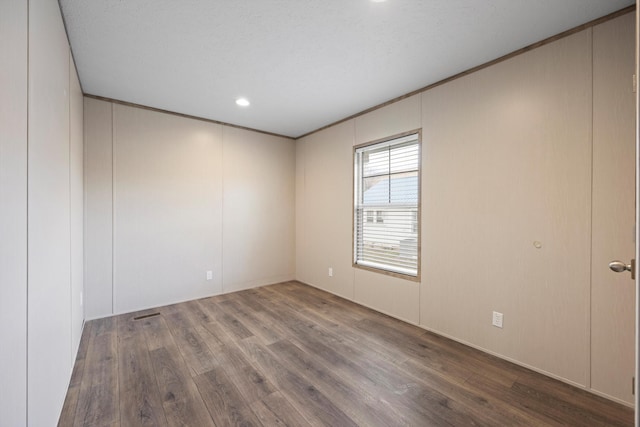 unfurnished room with hardwood / wood-style flooring