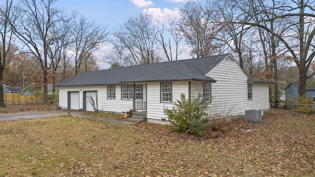 view of front of house featuring central AC unit and a garage