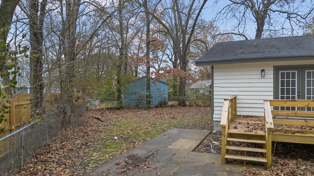 view of yard with a wooden deck and french doors