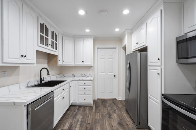 kitchen with light stone countertops, sink, stainless steel appliances, dark hardwood / wood-style flooring, and white cabinets