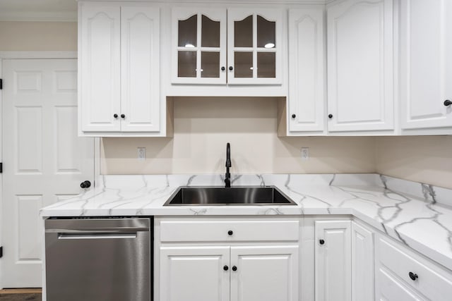 kitchen with dishwasher, white cabinetry, light stone countertops, and sink