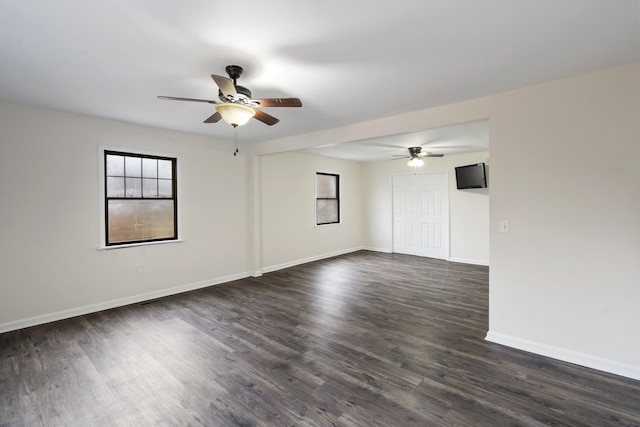 unfurnished room featuring ceiling fan and dark wood-type flooring