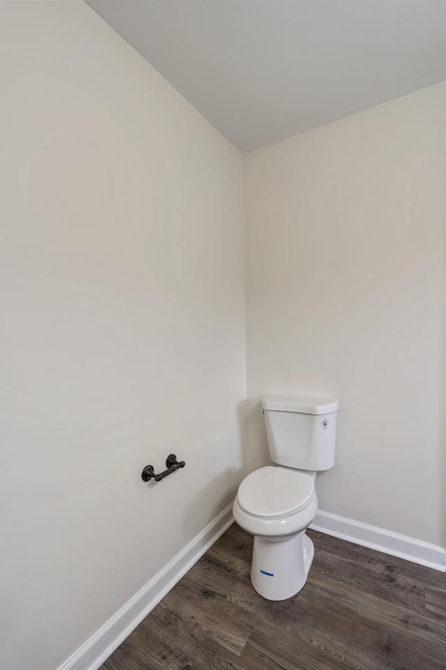 bathroom featuring wood-type flooring and toilet