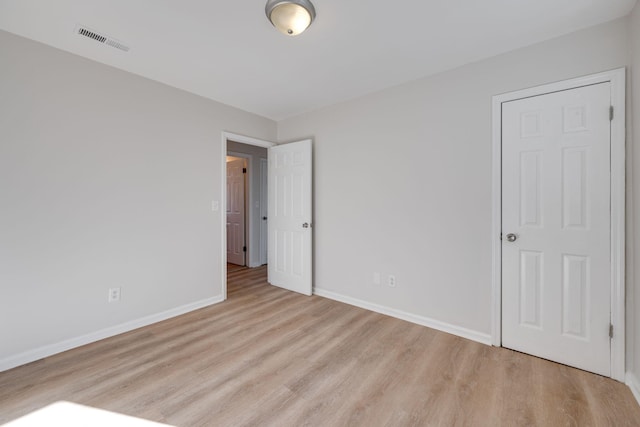 empty room with light hardwood / wood-style floors