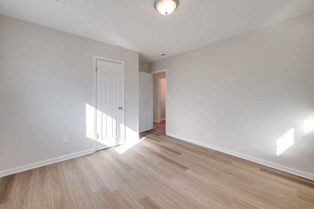 unfurnished room with light hardwood / wood-style floors