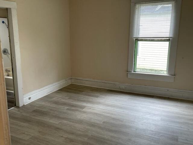 empty room with hardwood / wood-style floors