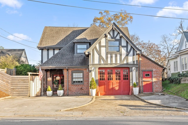 english style home featuring a garage