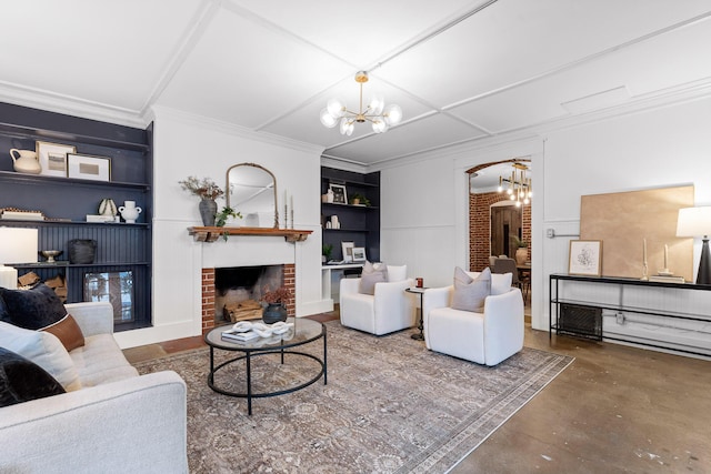 living room featuring crown molding, built in shelves, a fireplace, concrete floors, and a notable chandelier