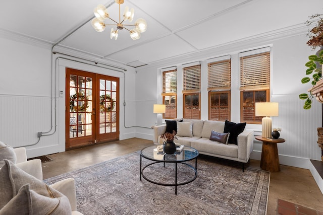 living room with a chandelier, crown molding, and french doors