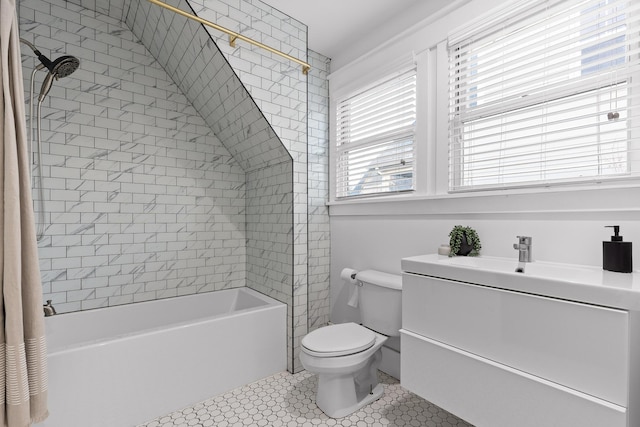 full bathroom with tile patterned floors, a wealth of natural light, and sink