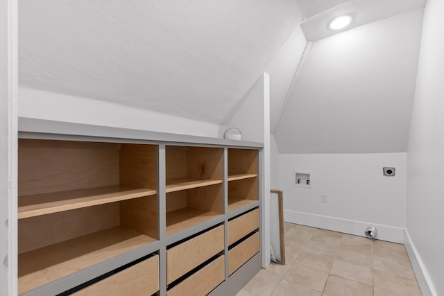 additional living space with light tile patterned floors and vaulted ceiling