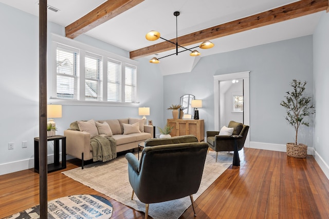 living room with a chandelier, wood-type flooring, and beam ceiling