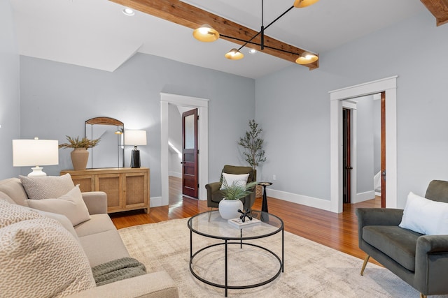 living room featuring beam ceiling and light wood-type flooring