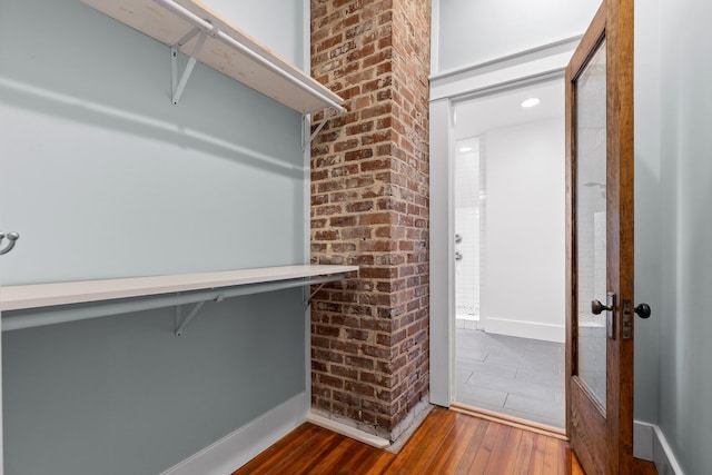 spacious closet with hardwood / wood-style flooring