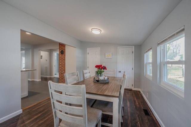 dining room featuring dark hardwood / wood-style floors and vaulted ceiling