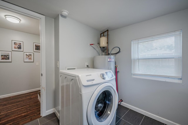 laundry area with electric water heater, dark hardwood / wood-style flooring, and washer / dryer