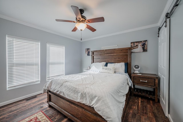 bedroom featuring dark hardwood / wood-style floors, ceiling fan, a barn door, and ornamental molding