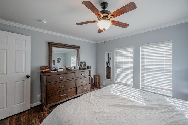 bedroom with dark hardwood / wood-style flooring, ceiling fan, and crown molding