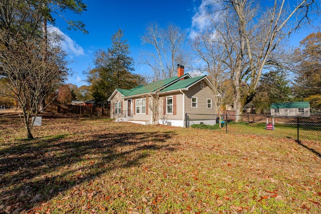 view of side of home featuring a yard