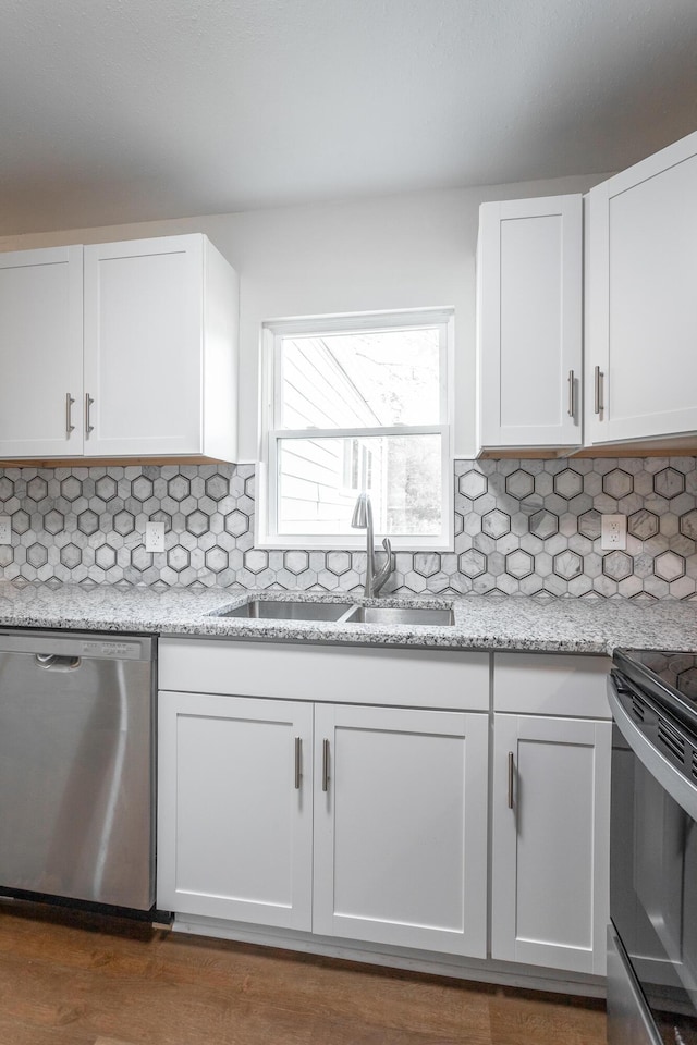 kitchen featuring white cabinets, backsplash, stainless steel appliances, and sink