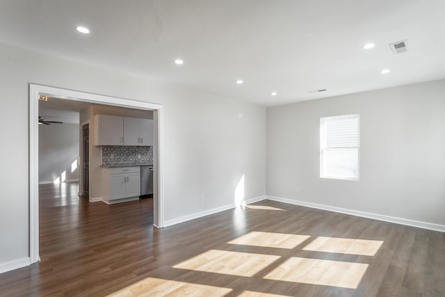 spare room featuring dark hardwood / wood-style flooring and ceiling fan