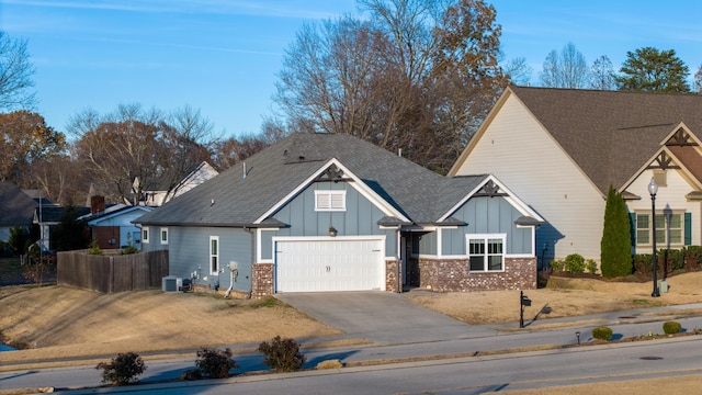 view of front of house with central air condition unit and a garage