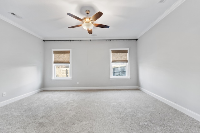 carpeted spare room featuring ceiling fan, plenty of natural light, and ornamental molding