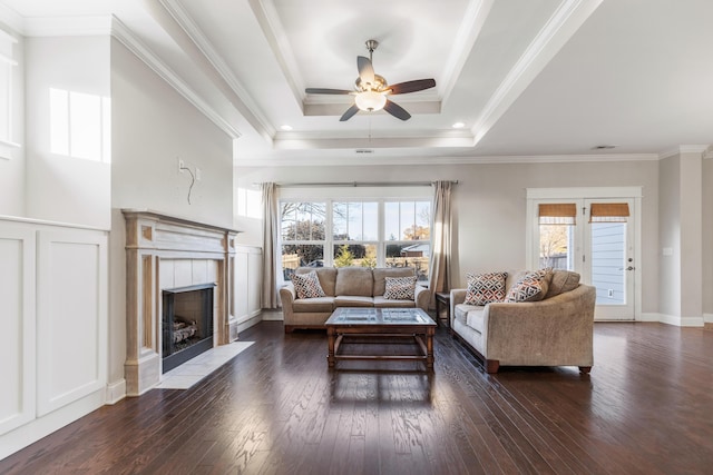 living room featuring plenty of natural light, ceiling fan, crown molding, and dark wood-type flooring