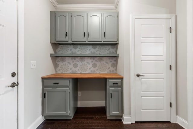 kitchen featuring butcher block countertops, crown molding, and dark wood-type flooring