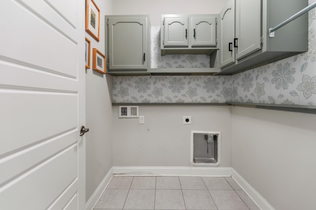 laundry room with electric dryer hookup, light tile patterned flooring, cabinets, and hookup for a washing machine