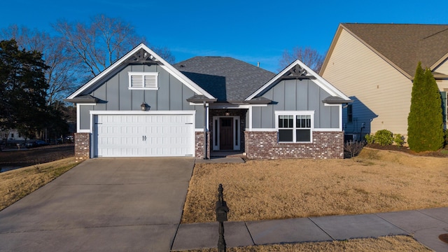 craftsman-style house with a garage, driveway, board and batten siding, and brick siding