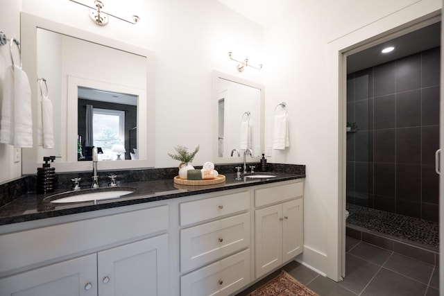 bathroom featuring tiled shower, vanity, and tile patterned floors