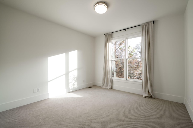 unfurnished room with light carpet