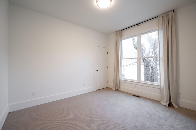 spare room with light colored carpet