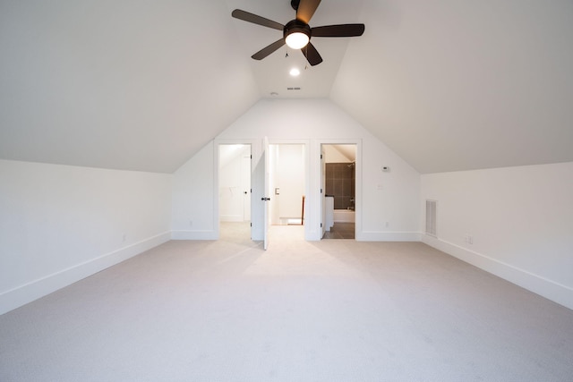 additional living space featuring ceiling fan, lofted ceiling, and light carpet