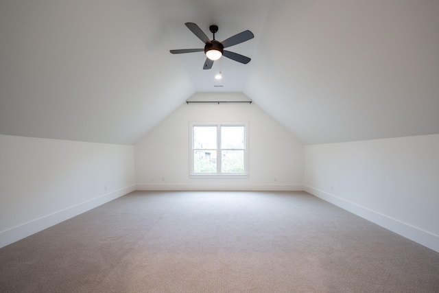 additional living space with ceiling fan, light colored carpet, and lofted ceiling