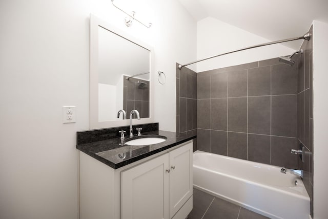 bathroom featuring vanity, tile patterned floors, and tiled shower / bath