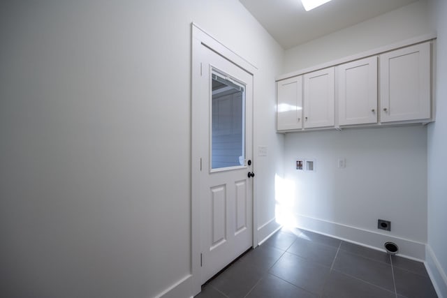 laundry area with cabinets, washer hookup, dark tile patterned flooring, and hookup for an electric dryer