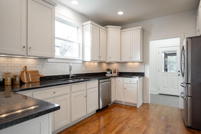 kitchen featuring hardwood / wood-style flooring, a healthy amount of sunlight, sink, and appliances with stainless steel finishes