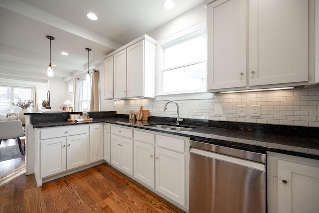 kitchen featuring sink, stainless steel dishwasher, dark hardwood / wood-style floors, decorative light fixtures, and white cabinets