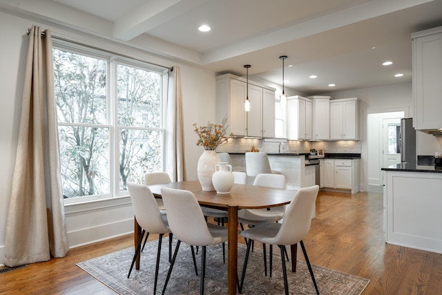 dining space featuring wood-type flooring and a wealth of natural light