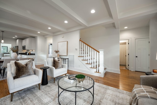 living room with beam ceiling and light wood-type flooring