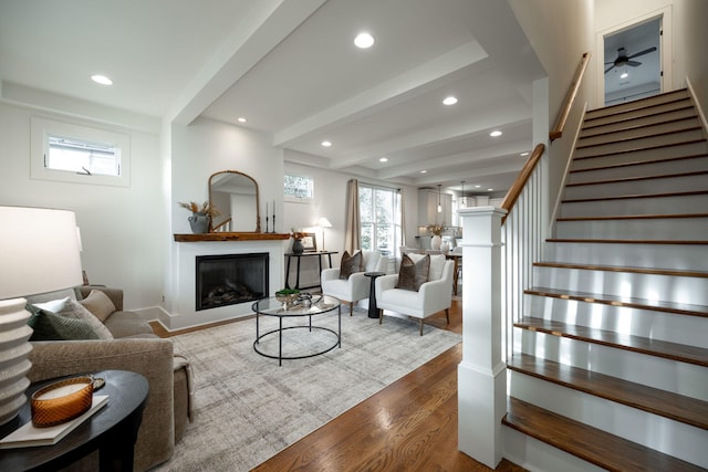 living room with hardwood / wood-style floors and beam ceiling